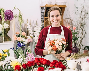 florist posing with bouquet