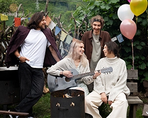 Playing the guitar with a smiley man and woman