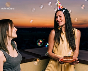 Birthday party at a house with two women wearing party hats